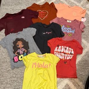Lot of new and used girls short sleeve shirts.